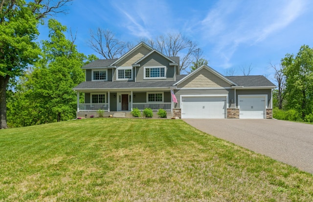 13284 288th Ave NW, Zimmerman, MN 55398 - view of front of home with a garage, asphalt driveway, covered porch, a front lawn, and stone siding