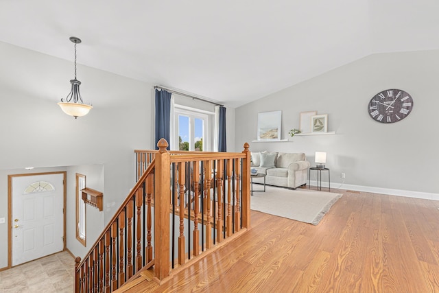 1112 Dakota St S, Shakopee, MN 55379 - stairway with lofted ceiling, baseboards, and wood finished floors