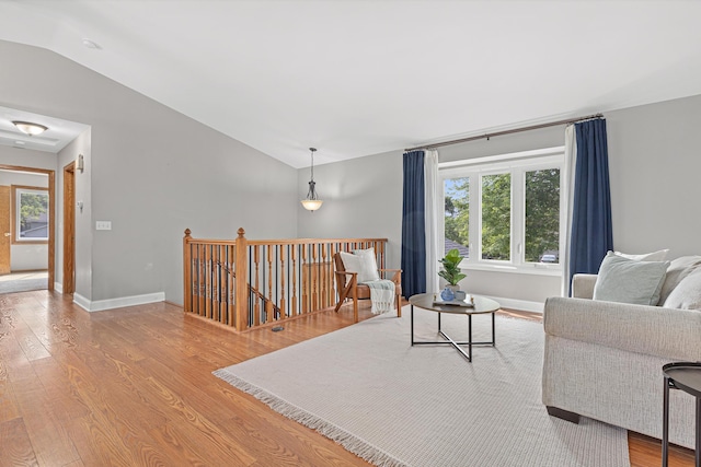 1112 Dakota St S, Shakopee, MN 55379 - living area with vaulted ceiling, wood finished floors, and baseboards