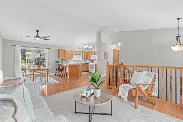 1112 Dakota St S, Shakopee, MN 55379 - living room with a chandelier, ceiling fan, light wood-type flooring, lofted ceiling, and baseboards