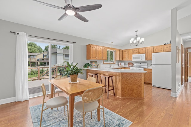 1112 Dakota St S, Shakopee, MN 55379 - dining space with a chandelier, lofted ceiling, light wood finished floors, a ceiling fan, and baseboards