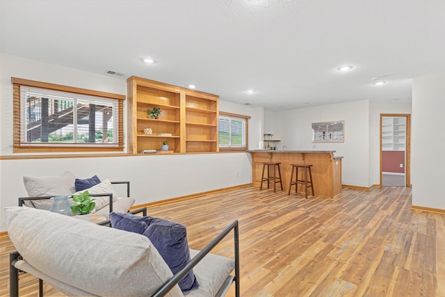 1112 Dakota St S, Shakopee, MN 55379 - living area with wet bar, light wood-style floors, recessed lighting, and baseboards