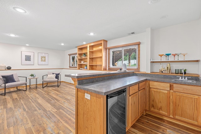 1112 Dakota St S, Shakopee, MN 55379 - kitchen featuring open shelves, beverage cooler, a sink, dark countertops, and wood finished floors