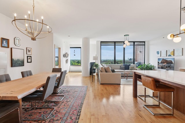 215 10th Ave S Unit 606, Minneapolis, MN 55415 - dining space featuring a chandelier, light wood finished floors, and a wall of windows