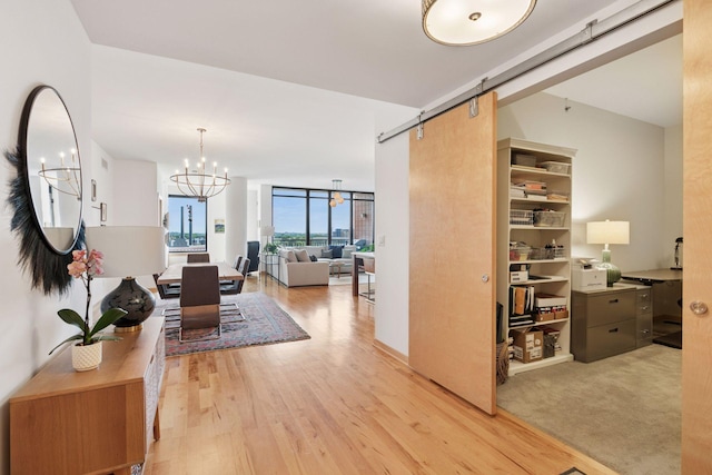 215 10th Ave S Unit 606, Minneapolis, MN 55415 - hall featuring a chandelier, a barn door, and wood finished floors