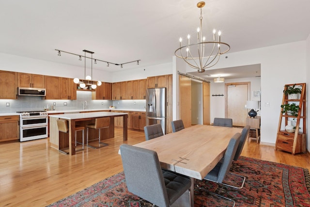 215 10th Ave S Unit 606, Minneapolis, MN 55415 - dining room with a chandelier and light wood-style flooring
