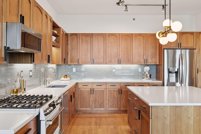 215 10th Ave S Unit 606, Minneapolis, MN 55415 - kitchen with stainless steel appliances, light wood-type flooring, light countertops, backsplash, and pendant lighting