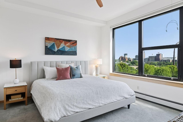 215 10th Ave S Unit 606, Minneapolis, MN 55415 - carpeted bedroom featuring a baseboard heating unit, a view of city, and ceiling fan