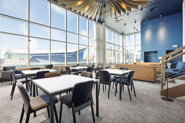 215 10th Ave S Unit 606, Minneapolis, MN 55415 - carpeted dining space with a high ceiling, floor to ceiling windows, and rail lighting