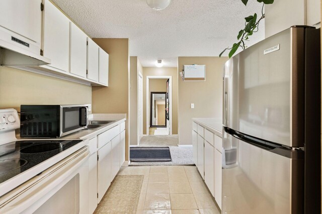 4130 Rahn Rd Unit 209, Eagan, MN 55122 - kitchen featuring appliances with stainless steel finishes, light countertops, under cabinet range hood, white cabinets, and a textured ceiling
