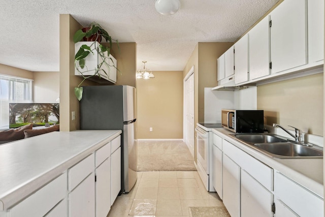 4130 Rahn Rd Unit 209, Eagan, MN 55122 - kitchen featuring a sink, freestanding refrigerator, white range with electric stovetop, a textured ceiling, and white cabinets