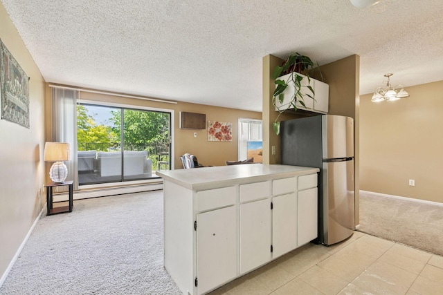 4130 Rahn Rd Unit 209, Eagan, MN 55122 - kitchen featuring freestanding refrigerator, light colored carpet, a baseboard heating unit, a textured ceiling, and white cabinetry