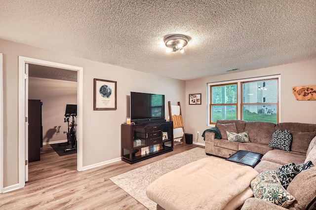 4271 Boulder Ridge Pt, Eagan, MN 55122 - living room featuring light wood-style floors, a textured ceiling, and baseboards