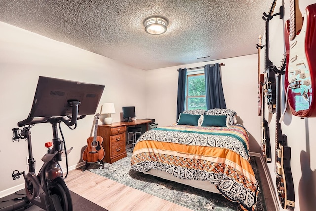 4271 Boulder Ridge Pt, Eagan, MN 55122 - bedroom featuring wood finished floors, a textured ceiling, and baseboards