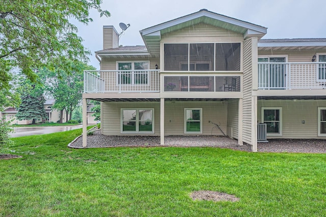 4271 Boulder Ridge Pt, Eagan, MN 55122 - back of house with a chimney, a yard, and a sunroom