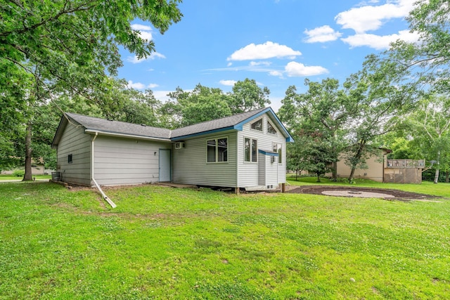 16724 Kenyon Cir NE, Ham Lake, MN 55304 - rear view of property featuring a lawn and roof with shingles