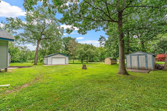 16724 Kenyon Cir NE, Ham Lake, MN 55304 - view of grassy yard featuring a storage shed, a detached garage, and view of scattered trees
