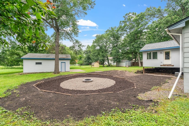 16724 Kenyon Cir NE, Ham Lake, MN 55304 - view of green lawn with a storage unit and an outdoor fire pit