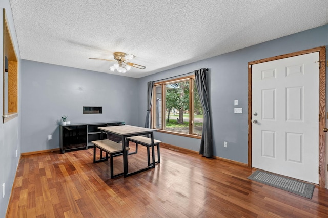 16724 Kenyon Cir NE, Ham Lake, MN 55304 - dining space featuring wood finished floors, a textured ceiling, and a ceiling fan