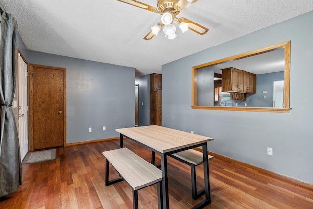 16724 Kenyon Cir NE, Ham Lake, MN 55304 - dining space with wood finished floors, ceiling fan, and a textured ceiling