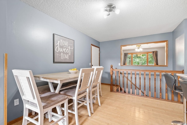 16724 Kenyon Cir NE, Ham Lake, MN 55304 - dining room featuring a textured ceiling and wood finished floors