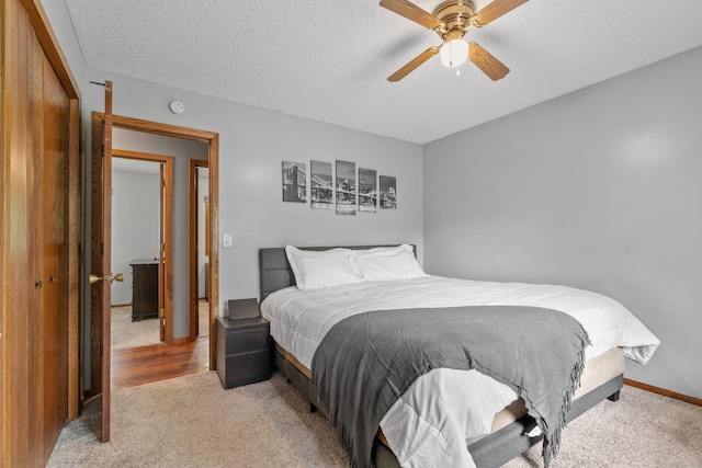 16724 Kenyon Cir NE, Ham Lake, MN 55304 - bedroom with light carpet, a ceiling fan, and a textured ceiling