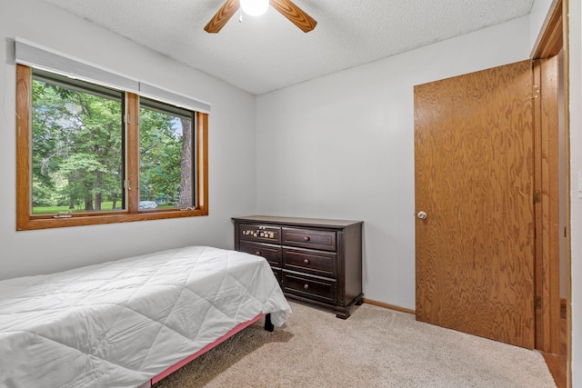16724 Kenyon Cir NE, Ham Lake, MN 55304 - carpeted bedroom featuring a textured ceiling and ceiling fan