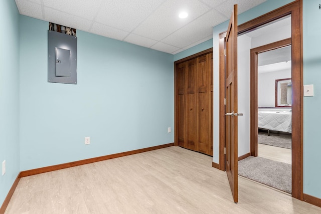 16724 Kenyon Cir NE, Ham Lake, MN 55304 - unfurnished bedroom with electric panel, wood finished floors, a closet, and a drop ceiling