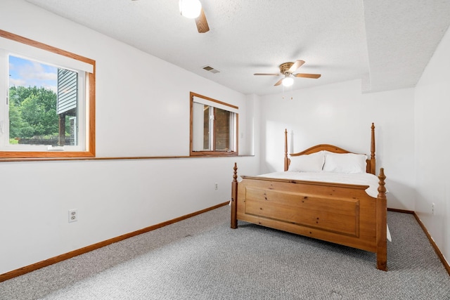 16724 Kenyon Cir NE, Ham Lake, MN 55304 - carpeted bedroom with ceiling fan and a textured ceiling