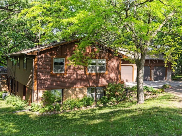 24810 96th St NW, Zimmerman, MN 55398 - view of home's exterior featuring concrete driveway, a yard, and a garage