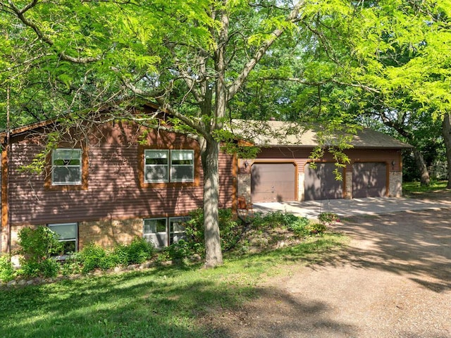 24810 96th St NW, Zimmerman, MN 55398 - view of front facade with driveway, an attached garage, and brick siding