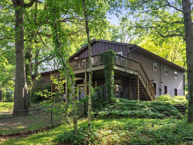 24810 96th St NW, Zimmerman, MN 55398 - rear view of house with stairs, a wooden deck, and board and batten siding