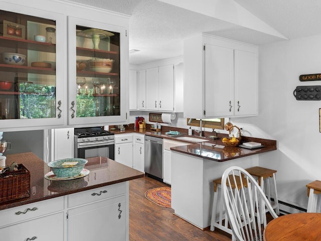 24810 96th St NW, Zimmerman, MN 55398 - kitchen featuring stainless steel appliances, white cabinets, a peninsula, dark wood-style flooring, and a textured ceiling
