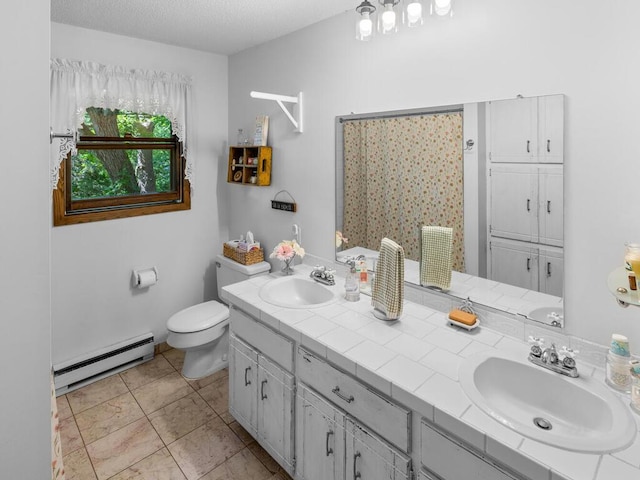 24810 96th St NW, Zimmerman, MN 55398 - bathroom with a baseboard radiator, double vanity, and a textured ceiling