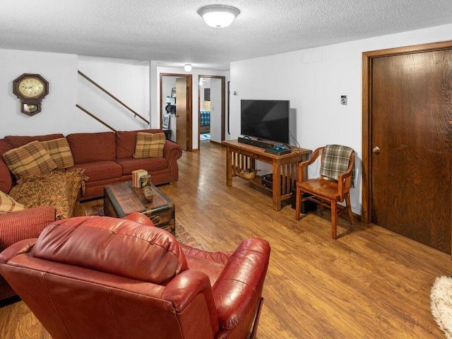 24810 96th St NW, Zimmerman, MN 55398 - living room with wood finished floors, a textured ceiling, and stairway