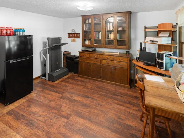 24810 96th St NW, Zimmerman, MN 55398 - kitchen featuring freestanding refrigerator, a textured ceiling, a desk, dark wood-style floors, and glass insert cabinets