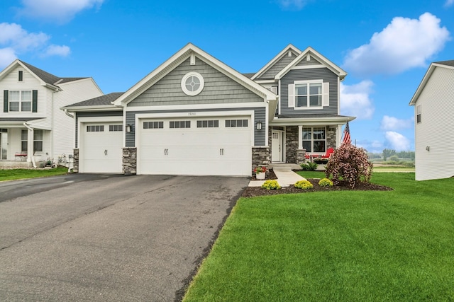 19281 Blue Stem Ct, Maple Grove, MN 55311 - craftsman-style house featuring stone siding, a garage, asphalt driveway, and a front lawn
