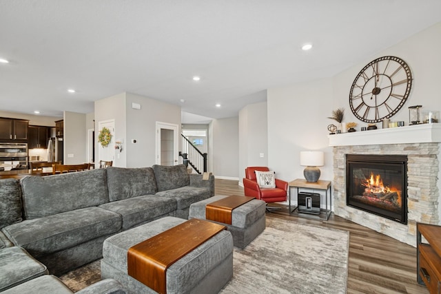 19281 Blue Stem Ct, Maple Grove, MN 55311 - living area featuring wood finished floors, recessed lighting, a stone fireplace, stairway, and baseboards