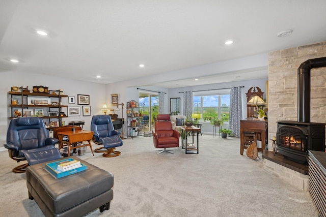 19281 Blue Stem Ct, Maple Grove, MN 55311 - living room featuring carpet flooring, a wood stove, and recessed lighting