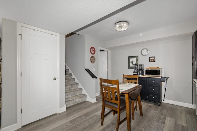 19281 Blue Stem Ct, Maple Grove, MN 55311 - dining room featuring dark wood finished floors, stairway, and baseboards
