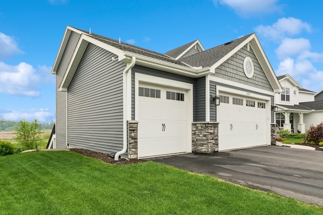 19281 Blue Stem Ct, Maple Grove, MN 55311 - view of side of property with an attached garage, a lawn, asphalt driveway, a shingled roof, and stone siding
