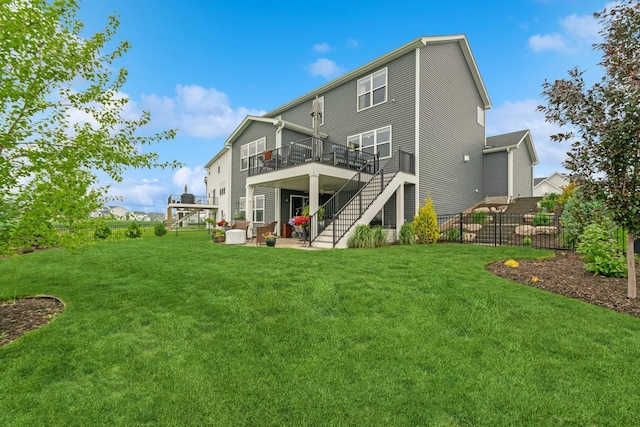 19281 Blue Stem Ct, Maple Grove, MN 55311 - back of property with stairway, a wooden deck, and a patio