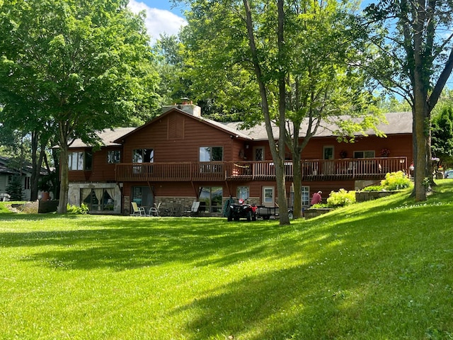 27862 Hidden Cove Rd, Collegeville, MN 56320 - back of house featuring stone siding, a yard, a chimney, and a wooden deck