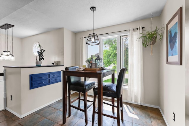 2708 94th Ave N, Brooklyn Park, MN 55444 - dining room with healthy amount of natural light, baseboards, a textured ceiling, and stone tile flooring