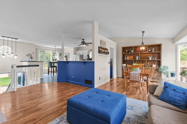 2708 94th Ave N, Brooklyn Park, MN 55444 - living room featuring plenty of natural light, wood finished floors, ceiling fan, and baseboards