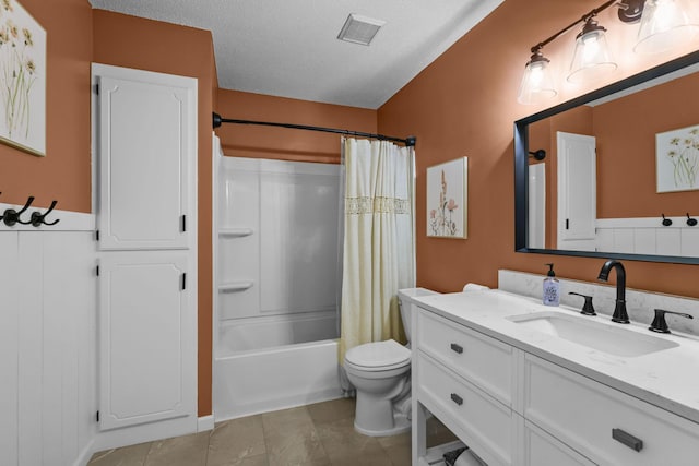 2708 94th Ave N, Brooklyn Park, MN 55444 - full bathroom with vanity, toilet, shower / bath combo with shower curtain, a textured ceiling, and tile patterned flooring