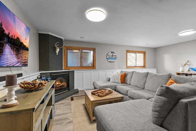 2708 94th Ave N, Brooklyn Park, MN 55444 - living area with light wood-style flooring, a fireplace, and a wainscoted wall