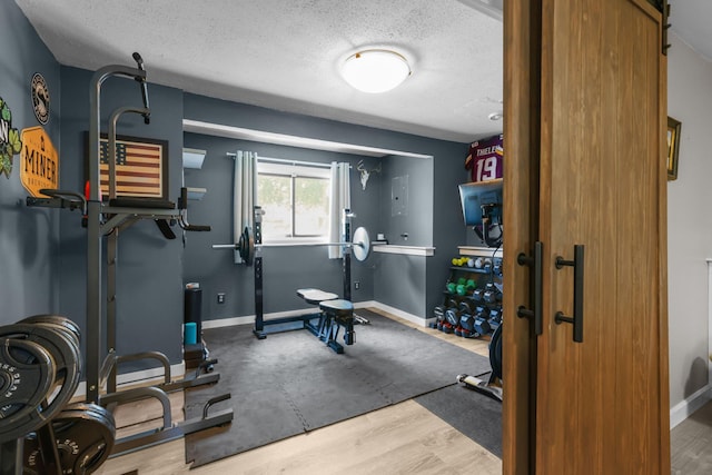 2708 94th Ave N, Brooklyn Park, MN 55444 - exercise area featuring a textured ceiling, baseboards, and wood finished floors