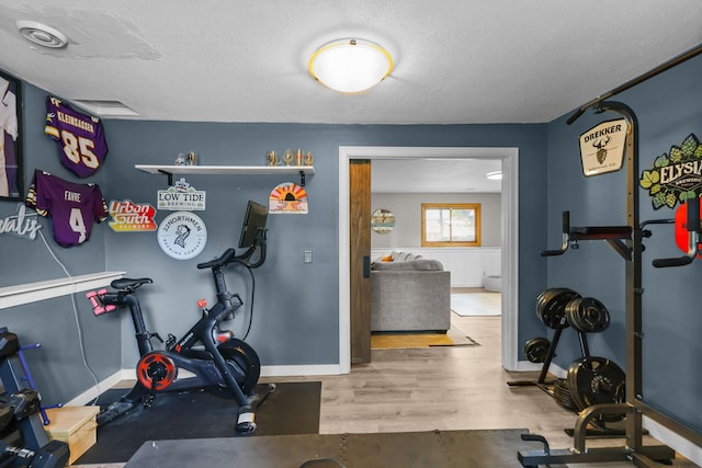 2708 94th Ave N, Brooklyn Park, MN 55444 - workout room with baseboards, wood finished floors, and a textured ceiling