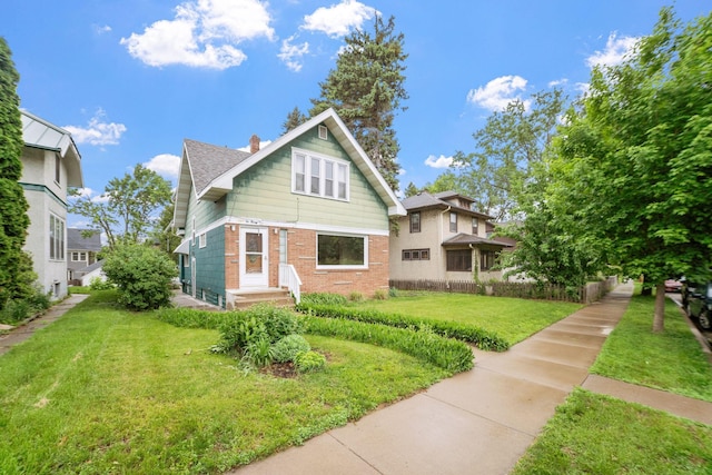 1027 Van Slyke Ave, Saint Paul, MN 55103 - view of front facade featuring brick siding, a front lawn, a chimney, and roof with shingles